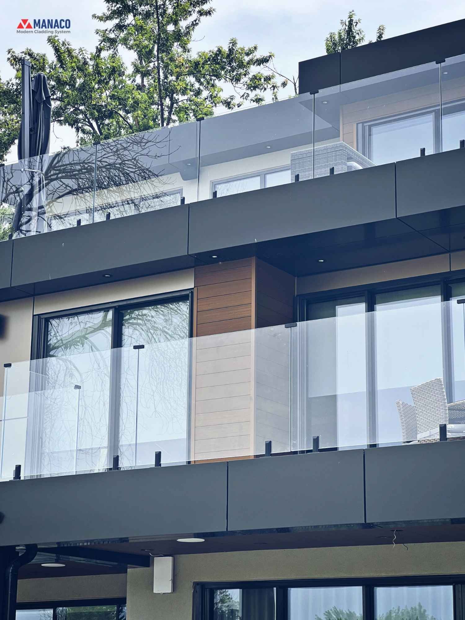 Elevation showing three levels with Bronze ACM balcony bands and glass railings